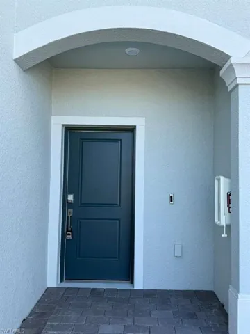 View of exterior entry with stucco siding