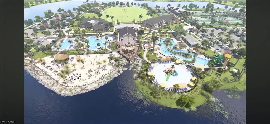 Drone / aerial view of a nearby body of water and a pool