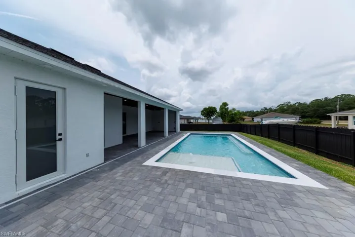 View of pool featuring a patio and a fenced backyard