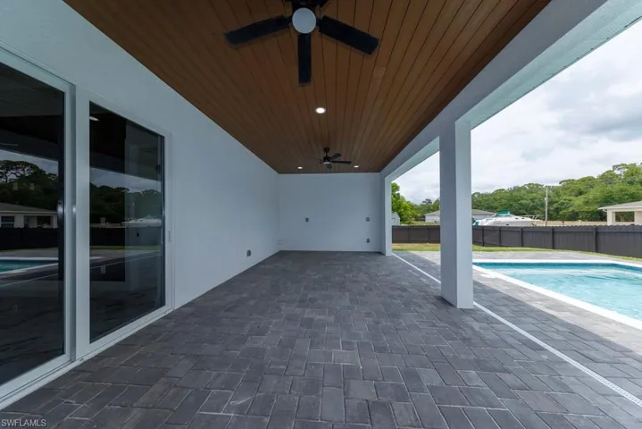 View of patio / terrace featuring ceiling fan and fence