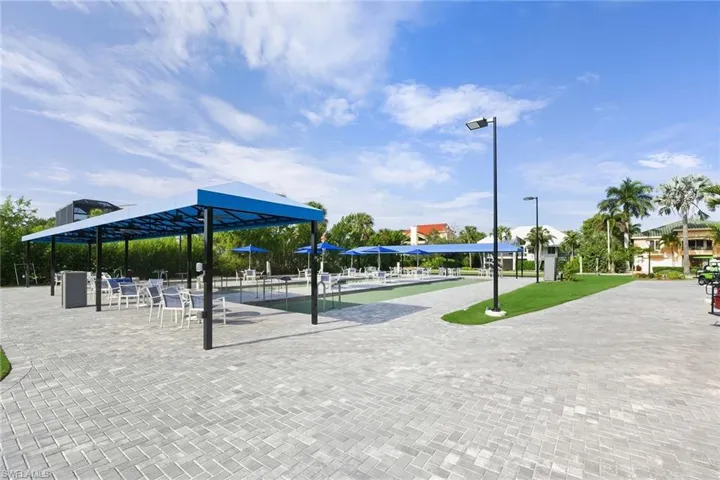 View of home's community with a bocce ball area and a patio area