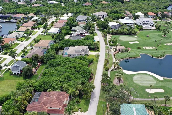 Aerial overview of property's location with a nearby body of water and nearby suburban area