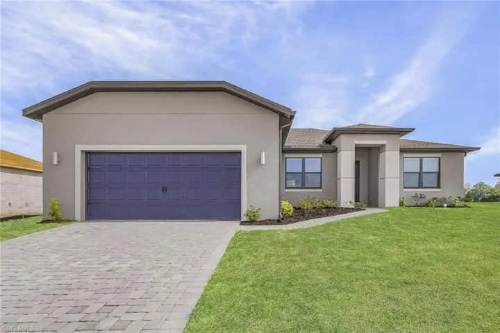 View of front facade featuring a garage and a front yard