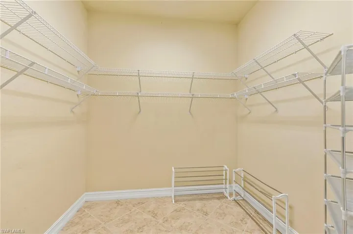Walk in closet with tile patterned floors
