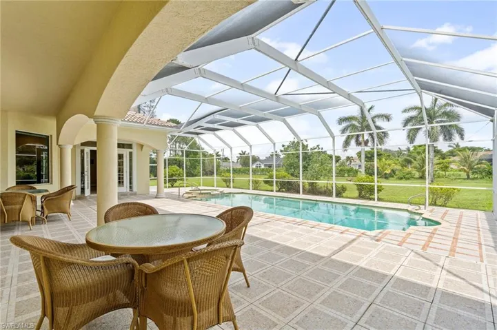 Outdoor pool with a patio, french doors, glass enclosure, and outdoor dining area