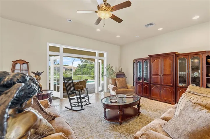 Living area featuring recessed lighting, a ceiling fan, and light tile patterned flooring