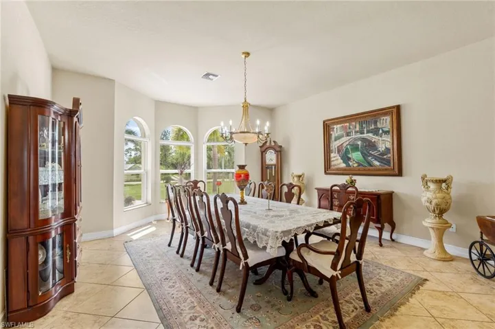Dining area featuring light tile patterned floors and a chandelier