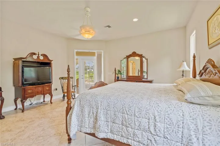 Bedroom with access to exterior, light tile patterned floors, and recessed lighting