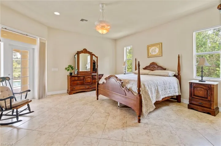 Bedroom with light tile patterned floors and recessed lighting
