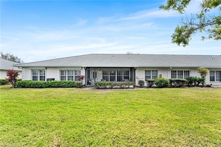 Single story home with a sunroom, stucco siding, and a front yard