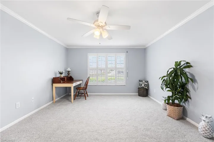 Office with carpet, crown molding, and baseboards