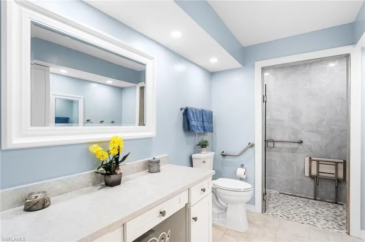 Full bath with recessed lighting, toilet, vanity, tile patterned flooring, and tiled shower