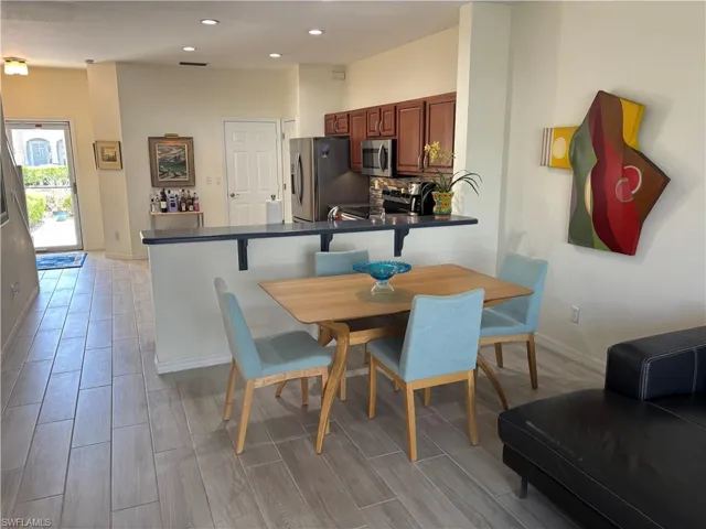 Dining area featuring wood finish floors and recessed lighting