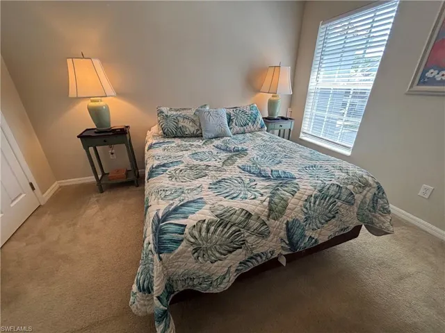 Bedroom with light colored carpet
