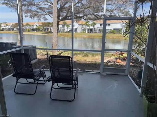 Sunroom featuring a water view, healthy amount of natural light, and a residential view
