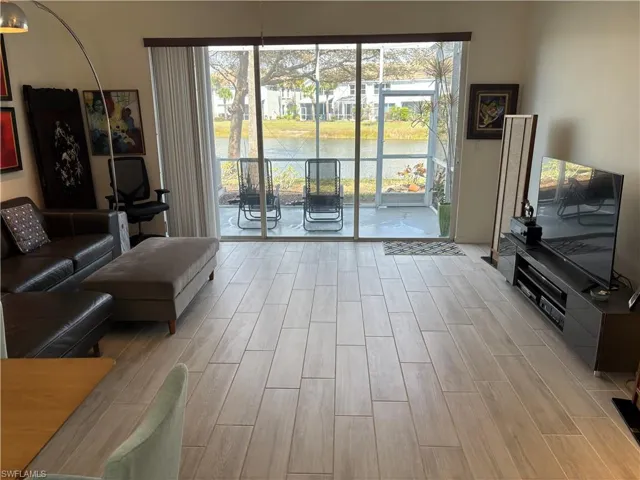 Living room featuring wood tiled floors and healthy amount of natural light