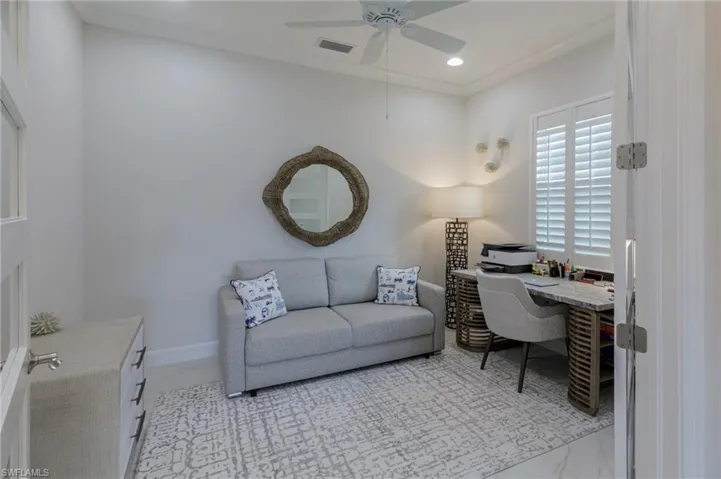 Office space with ceiling fan and crown molding