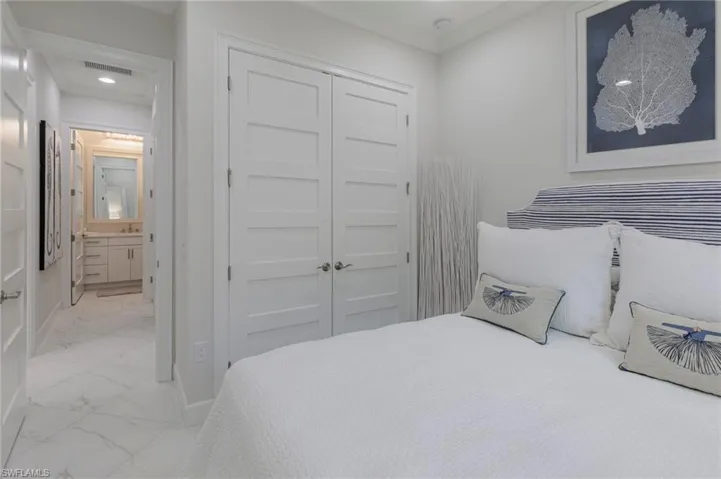 Bedroom featuring ensuite bathroom and a closet