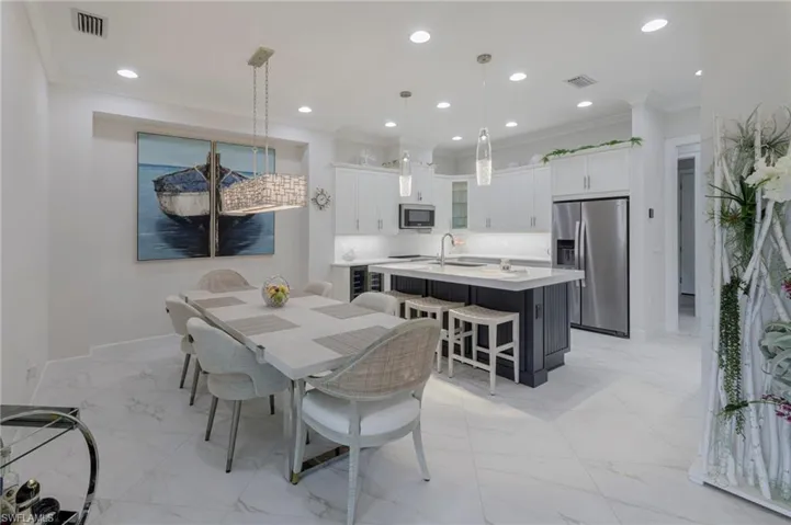 Dining area featuring crown molding and sink