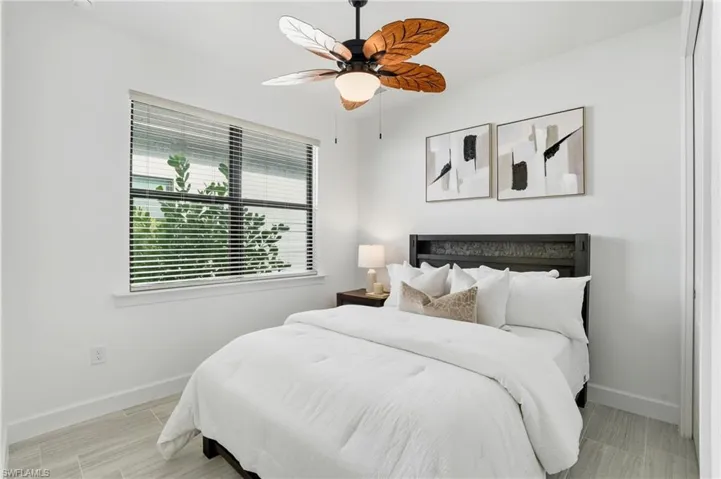 Bedroom featuring a ceiling fan and baseboards