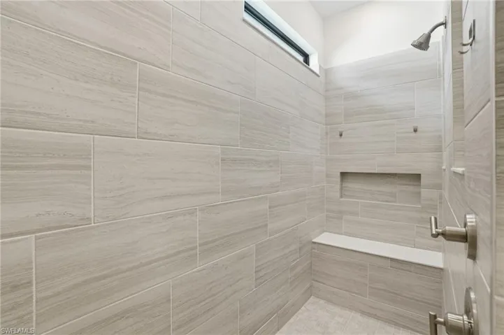 Full bath featuring a tile shower