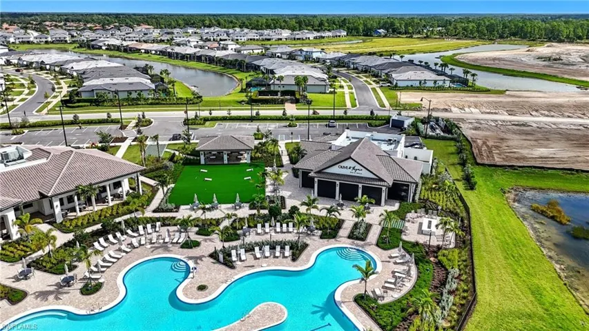 Aerial view of property's location featuring a nearby body of water and a pool area