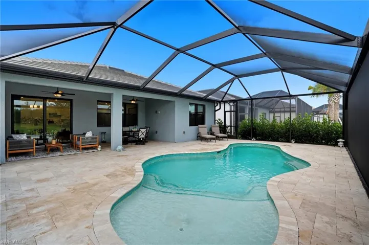Outdoor pool with a sunroom, an outdoor living space, a patio area, a lanai, and ceiling fan
