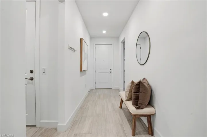 Corridor with baseboards and recessed lighting
