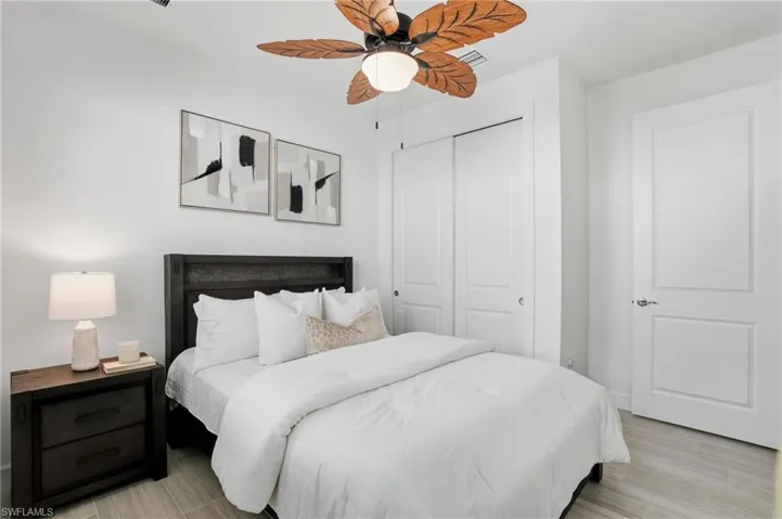 Bedroom featuring a closet, a ceiling fan, and wood finish floors