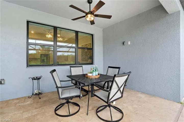 View of patio featuring outdoor dining space and a ceiling fan