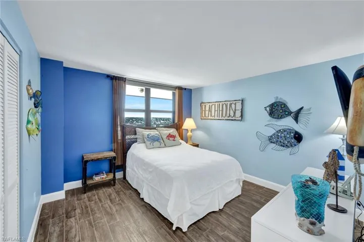 Bedroom featuring wood finish floors and a closet