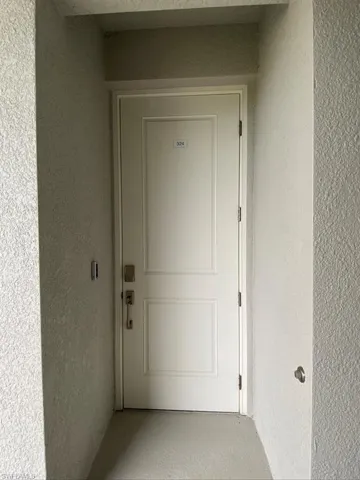 Entrance to property featuring stucco siding