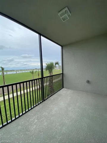 Balcony featuring a sunroom and a water view