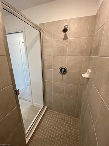 Full bathroom with a stall shower and tile patterned flooring