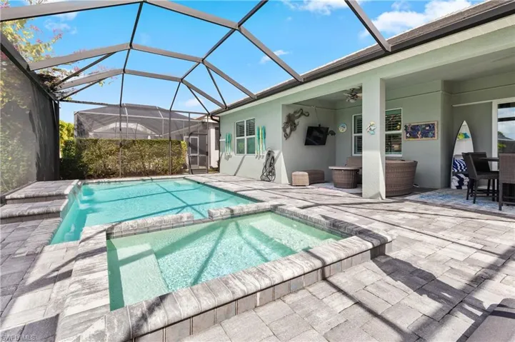 Integrated pool / spa featuring a sunroom, a lanai, a patio area, and outdoor seating