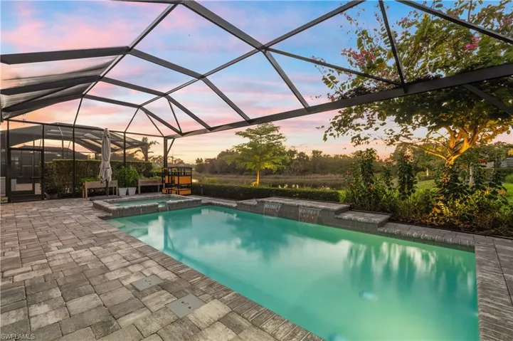 Combined pool / hot tub with a sunroom, a lanai, and a patio