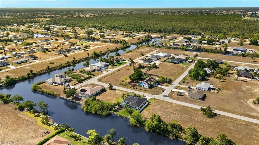 Aerial view with a residential view, a water view, and a wooded view