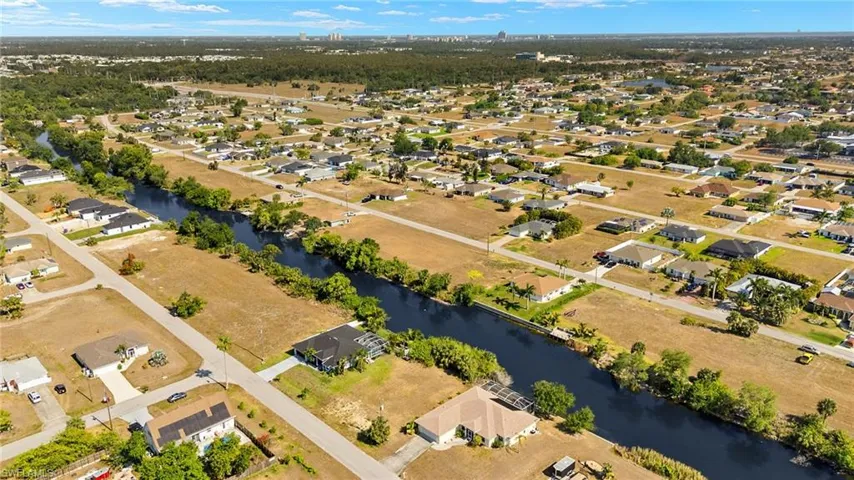 Birds eye view of property featuring a water view and a residential view