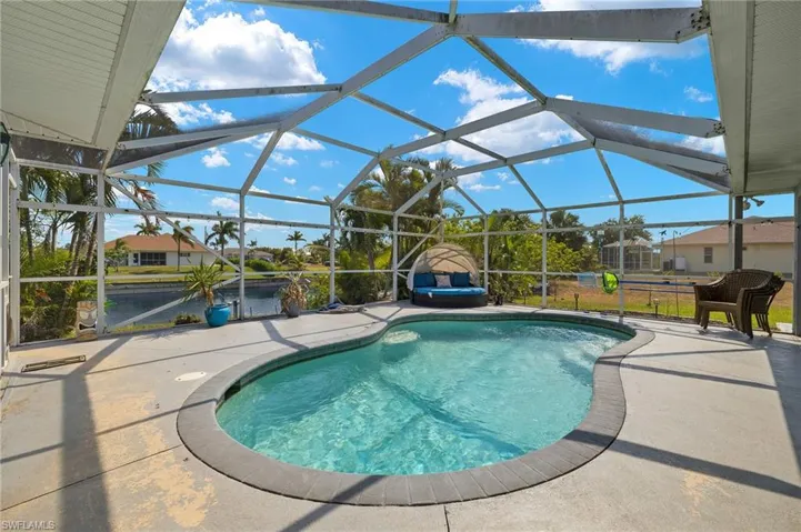 Pool with glass enclosure and a patio area