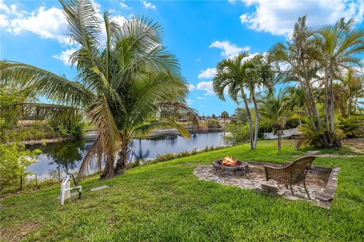 View of yard with a water view and an outdoor fire pit