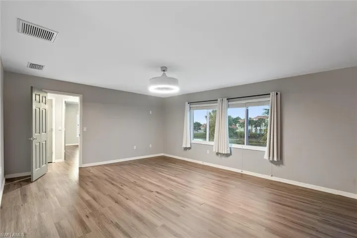 Spare room with light wood-type flooring and baseboards