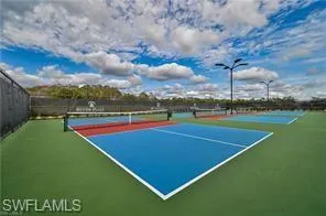View of tennis court featuring fence