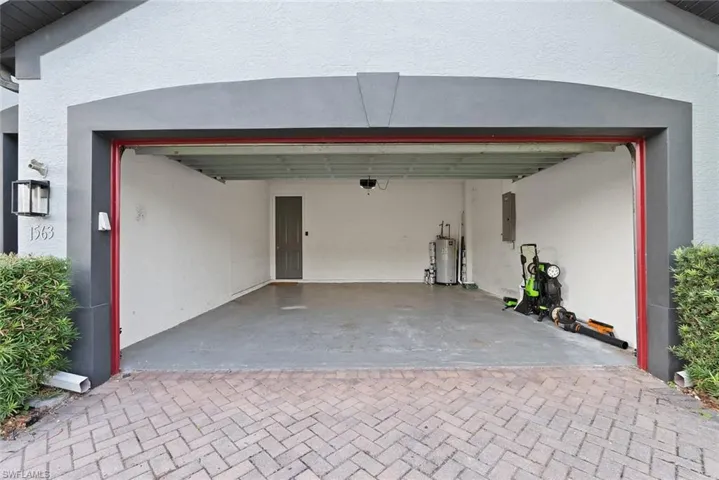 Garage with water heater and electric panel