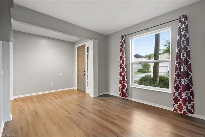 Unfurnished room featuring light wood-type flooring and baseboards