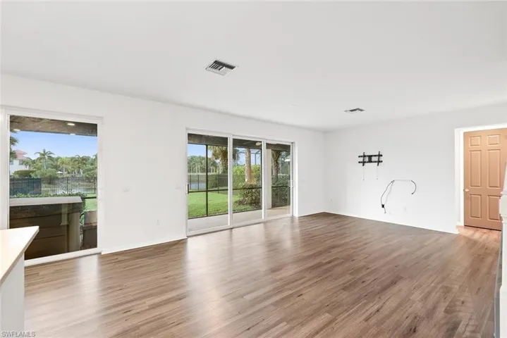 Unfurnished room with wood finished floors and baseboards
