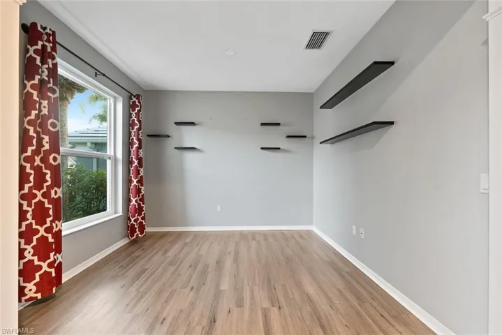 Spare room with light wood-style floors and baseboards