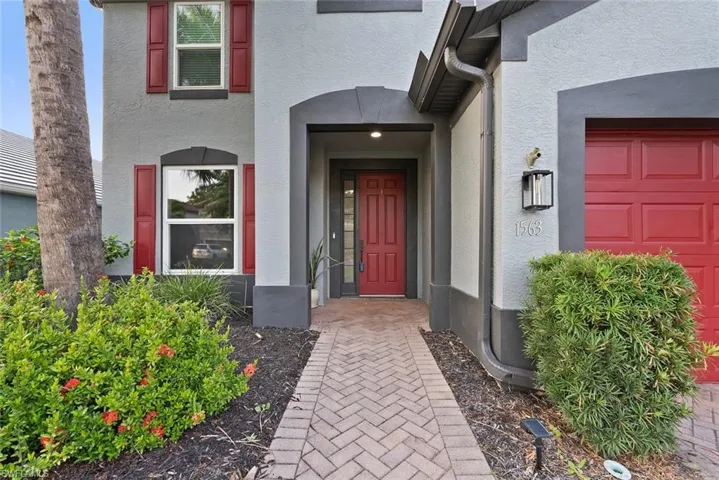 Doorway to property with stucco siding and an attached garage