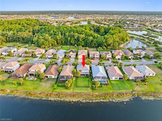 Aerial overview of property's location with a nearby body of water and nearby suburban area