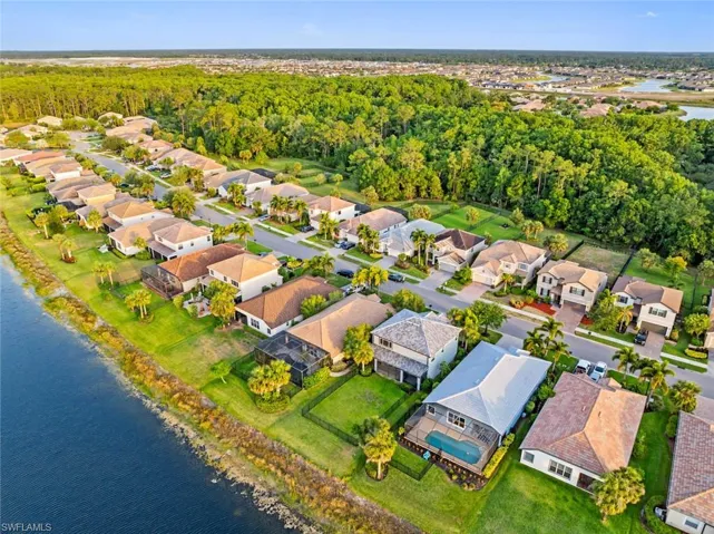 Aerial overview of property's location featuring a large body of water and nearby suburban area
