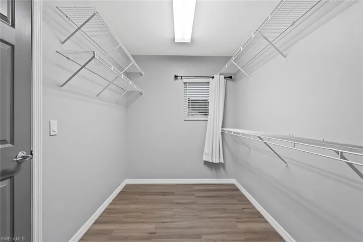 Spacious closet with wood finished floors